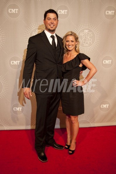 Josh Beckett and Holly Fisher attend CMT Artists of the Year at