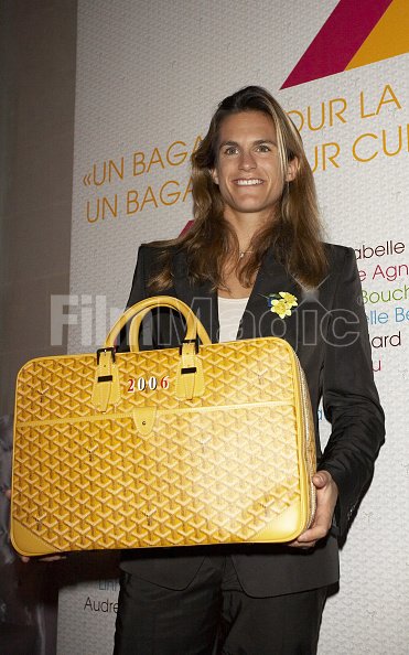 Amelie Mauresmo with the Goyard bag she designed during Auction of, FilmMagic