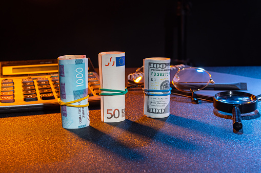 Three different currencies on the table. Bundles of money on the table. Inflation and exchange rate differences.