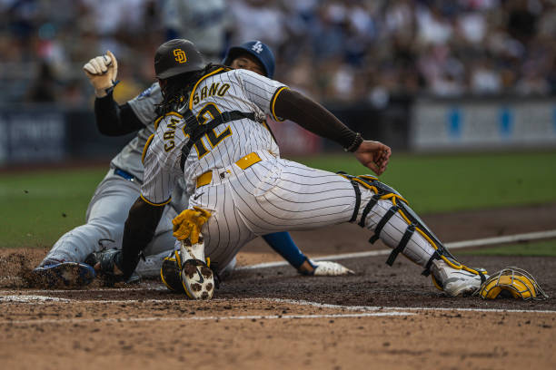Luis Campusano of the San Diego Padres tags out Shohei Ohtani of the Los Angeles Dodgers at home plate in the third inning at Petco Park on July 31,...