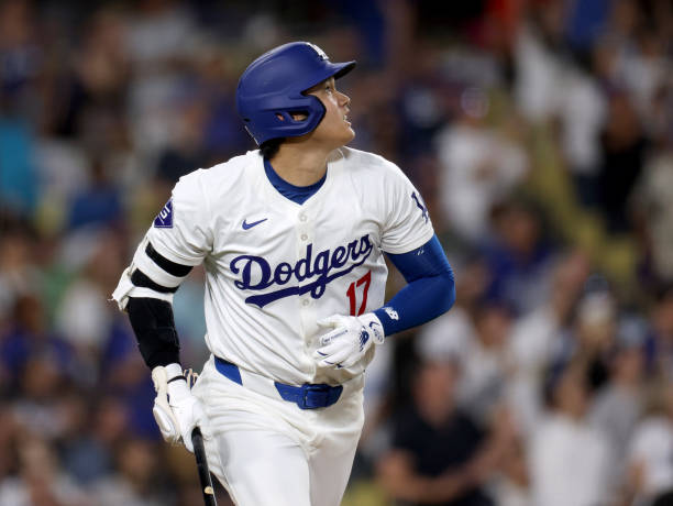 Shohei Ohtani of the Los Angeles Dodgers watches his solo home run, to take a 5-3 lead over the Philadelphia Phillies, during the eighth inning at...