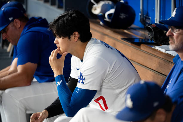 Shohei Ohtani of Los Angeles Dodgers looks on in the bottom of the ninth inning during the regular season game against the Philadelphia Phillies at...