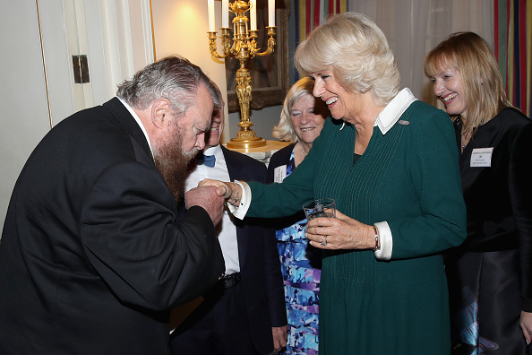 actor-brian-blessed-kisses-the-hand-of-camilla-duchess-of-cornwall-as-picture-id862337016
