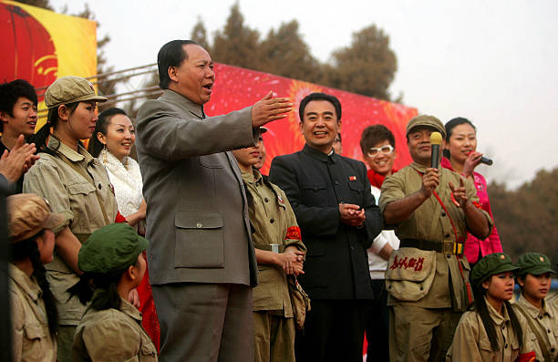 Actors depicting the late Chinese leaders Mao Zedong and Zhou Enlai perform at the Ditan Temple Fair during Chinese New Year celebrations on January...