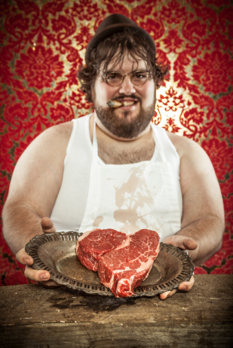 butcher-holding-a-heart-shaped-steak-for-valentines-day-picture-id143175188