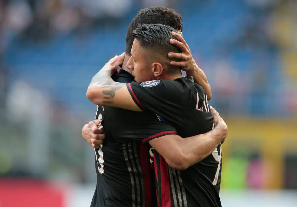 carlos-bacca-of-ac-milan-embraces-gianluca-lapadula-of-ac-milan-the-picture-id666500876