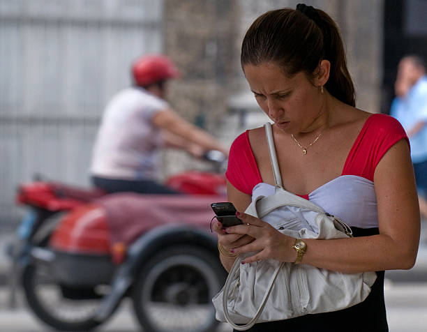 A Cuban woman uses her mobile phone in a street of Havana on May 20, 2010.