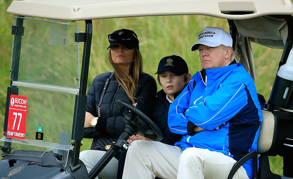 Donald Trump watches the action with wife Melania and son Barron during the Third Round of the Ricoh Women's British Open at Turnberry Golf Club on...
