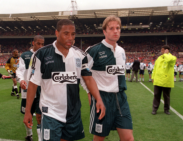 Football. 1996 FA Cup Final. Wembley. 11th May, 1996. Manchester United 1 v Liverpool 0. Liverpool players John Barnes (left) and John Scales walk off the pitch dejected at the end of the match. : News Photo