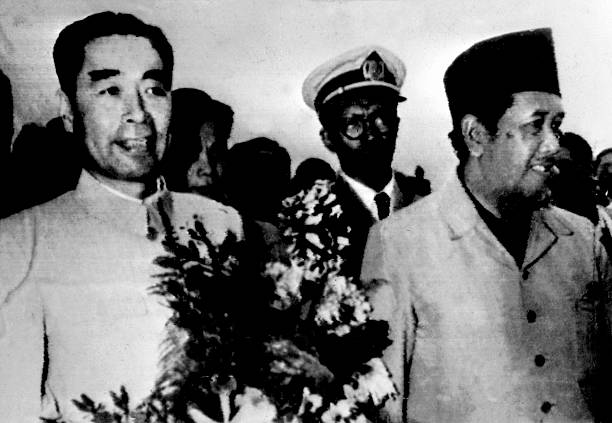 Foreign minister of People's Republic of China Zhou Enlai is welcomed by Indonesian Prime minister Aly SastoAmidjojo 18 April 1955 as he arrives at...