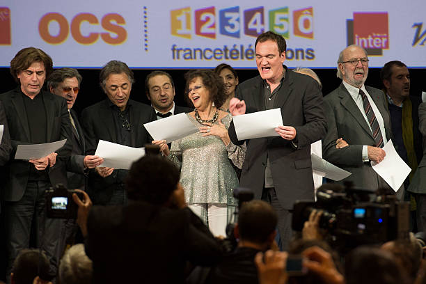 Jean Michel Jarre, Daniel Auteuil, Richard Berry, Patrick Timsit, Claudia Cardinale, Quentin Tarantino and Jean Pierre Marielle on stage during the Tribute to Jean Paul Belmondo and Opening Ceremony of the Fifth Lumiere Film Festival, in Lyon.