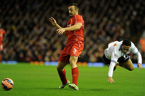 Jose Enrique of Liverpool competes with Liam Feeney of Bolton Wanderers during the FA Cup Fourth Round match between Liverpool and Bolton Wanderers...