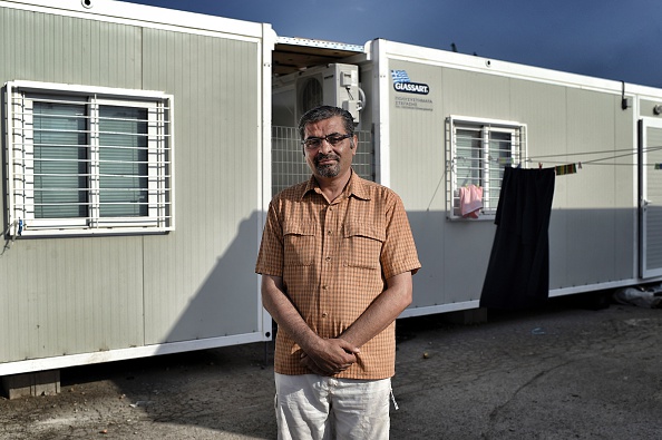 Kasem Alsabsabi poses at the refugee camp of Skaramangas, an industrial area near the port of Piraeus on June 28, 2016, during a 14-day visit to his family. His wife and their eight children live t...