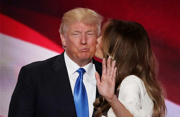 Melania Trump kisses her husband and presumptive Republican presidential nominee Donald Trump after delivering a speech on the first day of the...