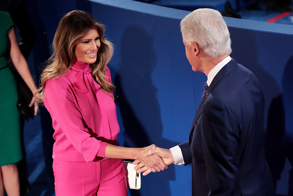 Melania Trump shakes hands with former US President Bill Clinton before the town hall debate at Washington University on October 9 2016 in St Louis...