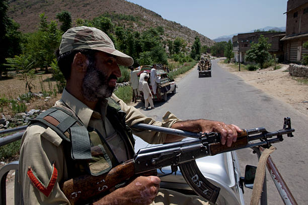 Pakistani Frontier Corps soldier patrols the streets via a truck during a media visit to the area June 23 2009 in Buner district Pakistan Over 19...