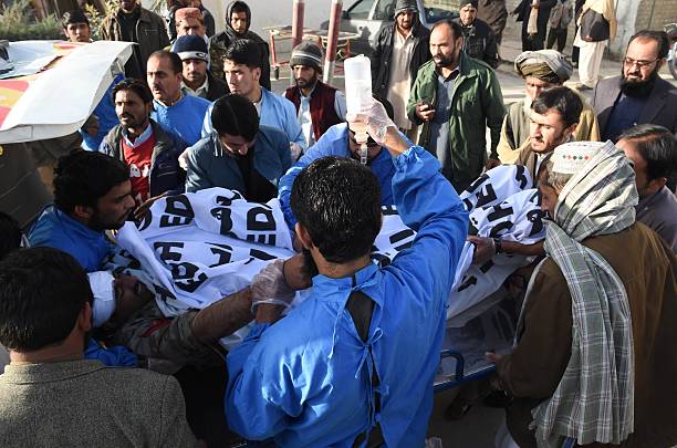 Pakistani paramedics shift an injured Frontier Corps member into a hospital after a bomb explosion in Quetta on December 12 2015 A frontier corps...