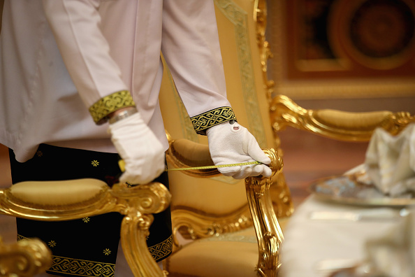palace-worker-measures-the-distance-between-chairs-with-a-tape-ahead-picture-id869265264