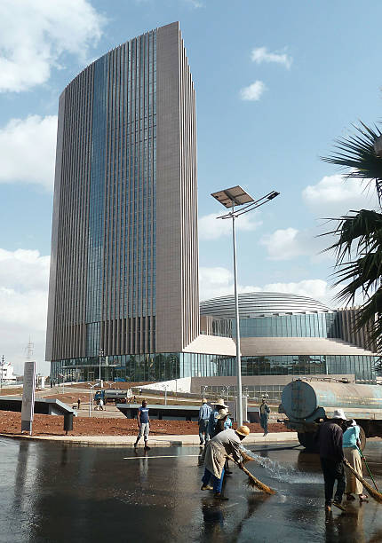People clean the streets in front of the new African Union headquarters in Addis Ababa on January 24 2012 The AU headquarters was built and fully...
