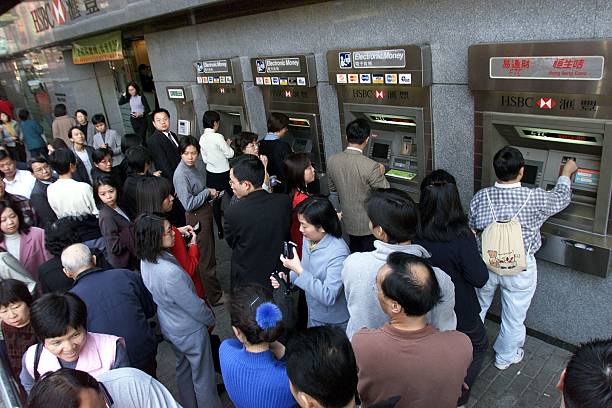 people-line-up-at-a-branch-of-hong-kong-banks-atm-machines-to-get-30-picture-id51344984