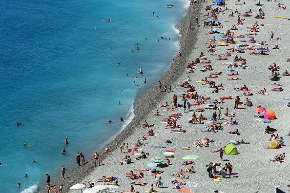 News Photo : People sunbath on the beach in Nice, on the... FRANCE-WEATHER : News Photo
