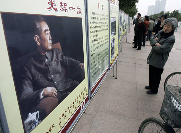 A visitor views portrait of late Chinese premier Zhou Enlai during a photo exhibition on the life of Zhou to mark the 110yearanniversary of his...