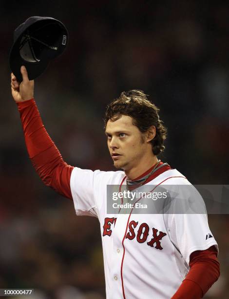 Clay Buchholz of the Boston Red Sox salutes the fans after he is pulled from the game in the top of the ninth inning against the Minnesota Twins on...