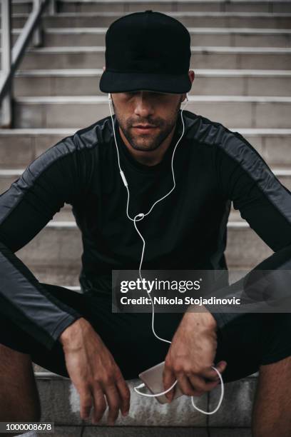 young man preparing to workout - sweatshirt stock pictures, royalty-free photos & images