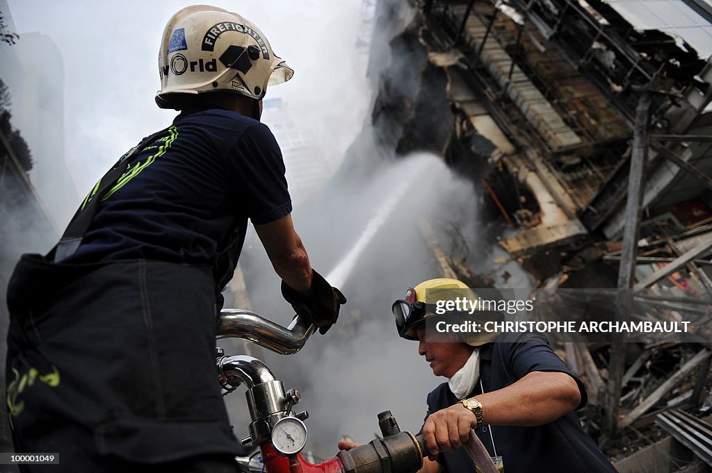 Thai firemen try to put douse the flames