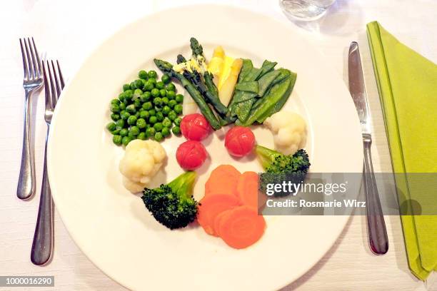 selection of cooked vegetables on white plate - steamed stock pictures, royalty-free photos & images