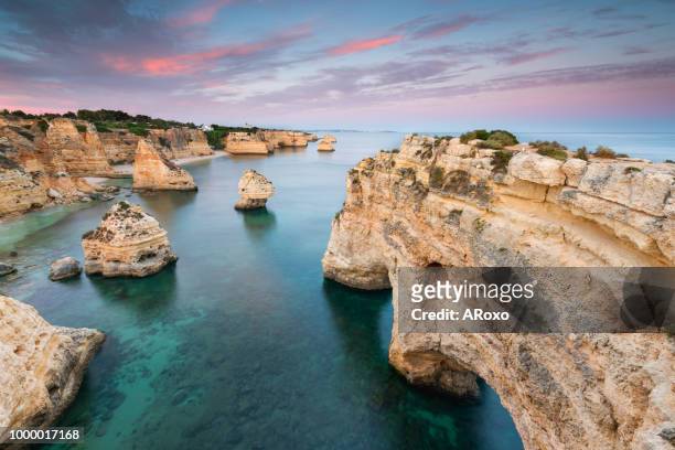 amazing sunset at marinha beach in the algarve, portugal. summer tourist attraction. - albufeira stock pictures, royalty-free photos & images
