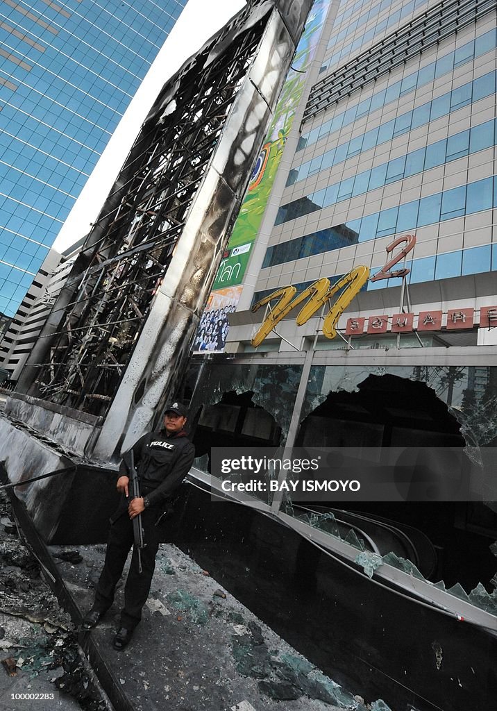 A policeman stands guard next to the bur