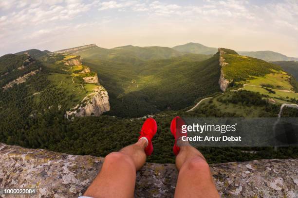 guy on a stunning viewpoint with nice green canyon formation. - green shoes stock pictures, royalty-free photos & images