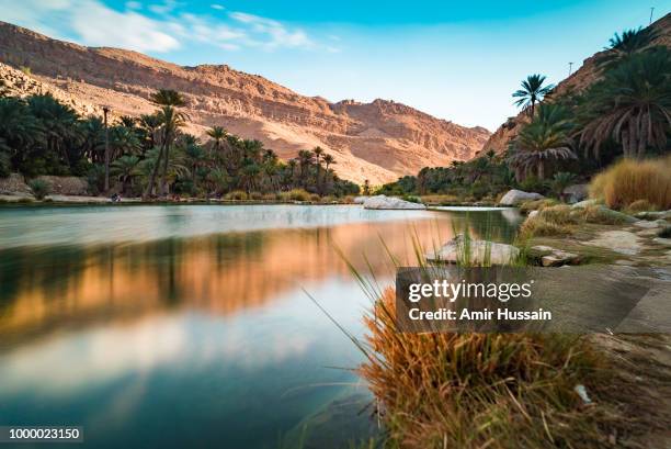 sun setting at wadi bani khalid - oman stockfoto's en -beelden