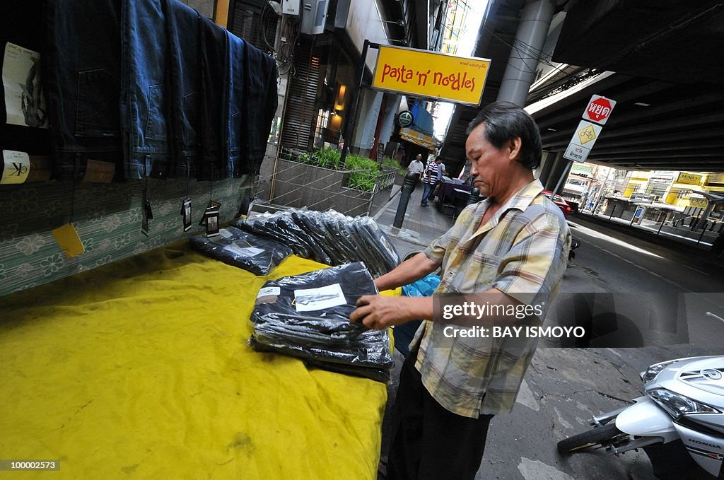 A street vendor sets up his products as