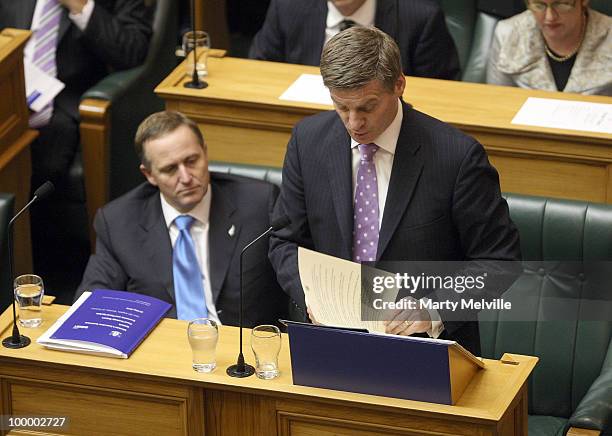 New Zealand's Finance Minister Bill English reads the Budget with the Prime Minister of New Zealand John Key looking on at Parliament House on May...