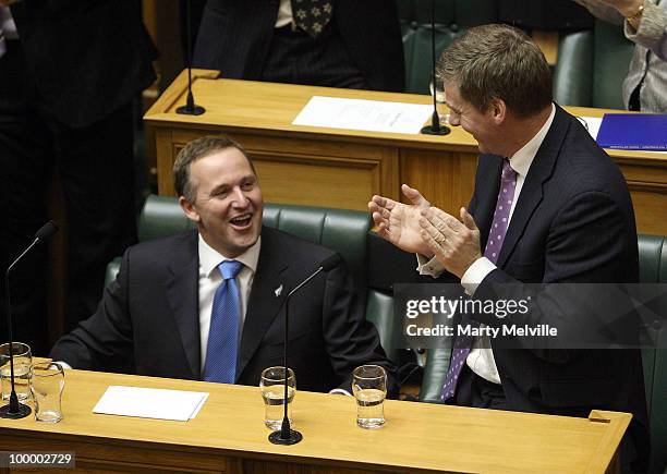 Minister of Finance Bill English congratulates Prime Minister of New Zealand John Key on his speech after the reading of the Budget in Parliament...