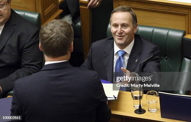 New Zealand's Finance Minister Bill English hands a copy of the budget to Prime Minister of New Zealand John Key before the reading of the Budget in...