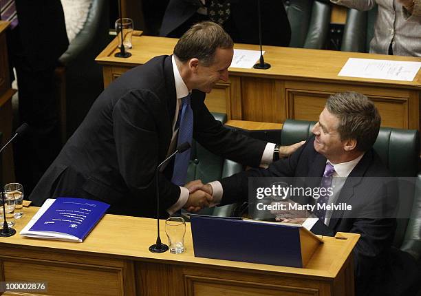 New Zealand's Finance Minister Bill English is congratulated by the Prime Minister of New Zealand John Key after the reading the Budget in Parliament...