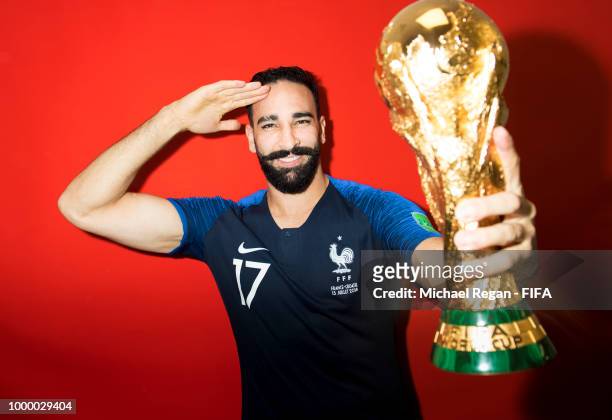 Adil Rami of France poses with the Champions World Cup trophy after the 2018 FIFA World Cup Russia Final between France and Croatia at Luzhniki...