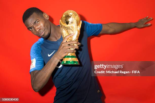 Paul Pogba of France poses with the Champions World Cup trophy after the 2018 FIFA World Cup Russia Final between France and Croatia at Luzhniki...