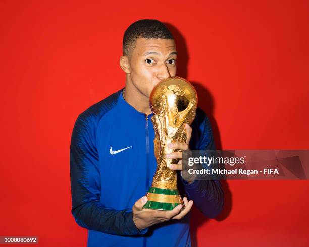 Kylian Mbappe of France poses with the Champions World Cup trophy after the 2018 FIFA World Cup Russia Final between France and Croatia at Luzhniki...