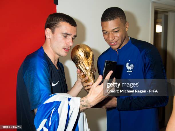 Antoine Griezmann and Kylian Mbappe of France pose with the Champions World Cup trophy after the 2018 FIFA World Cup Russia Final between France and...