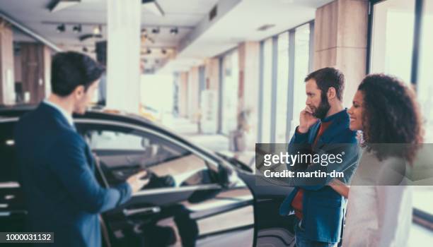 couple buying new car - audi showroom stock pictures, royalty-free photos & images