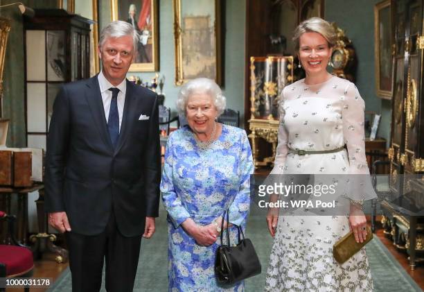 Queen Elizabeth II poses with King Philippe of Belgium and Queen Mathilde of Belgium in the Grand Corridor during their audience at Windsor Castle on...