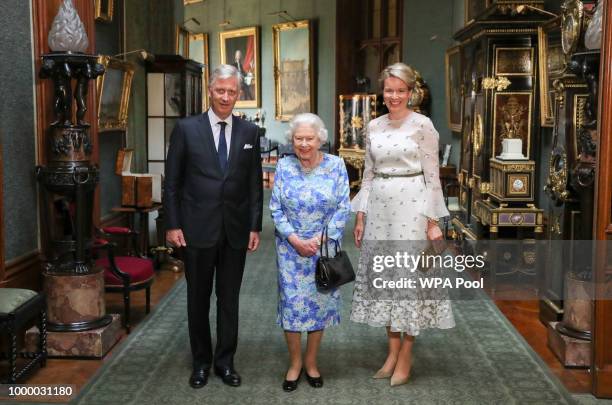 Queen Elizabeth II poses with King Philippe of Belgium and Queen Mathilde of Belgium in the Grand Corridor during their audience at Windsor Castle on...