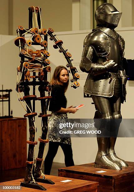 Woman walks past robotic models which form part of the Leonardo da Vinci exhibition Da Vinci Secrets 'Anatomy to Robots' at the Sydney Town Hall on...