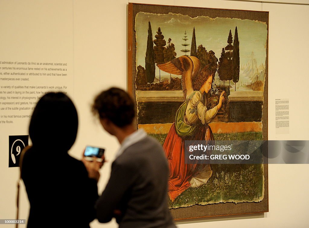 Two women inspect a reproduction of the