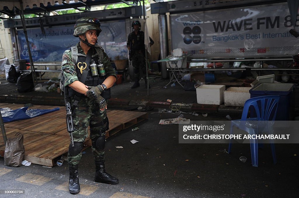 Armed soldiers stand guard at the abando