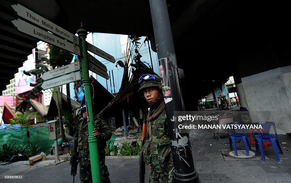 Thai soldiers take cover after hearing g